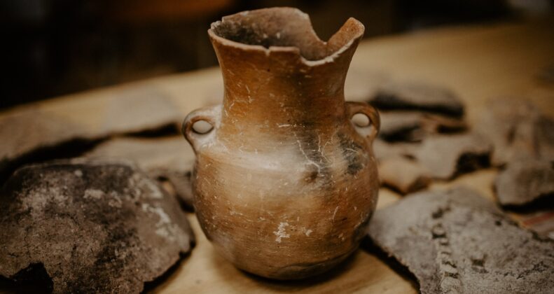 brown ceramic vase on brown wooden table