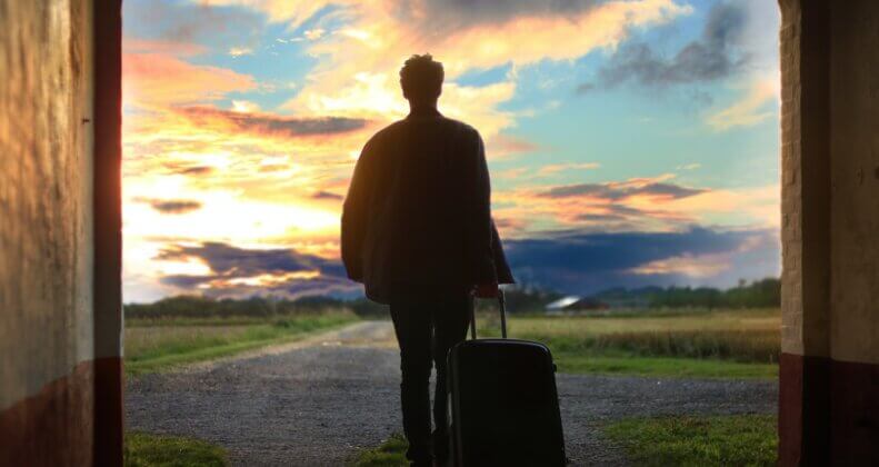 man holding luggage photo